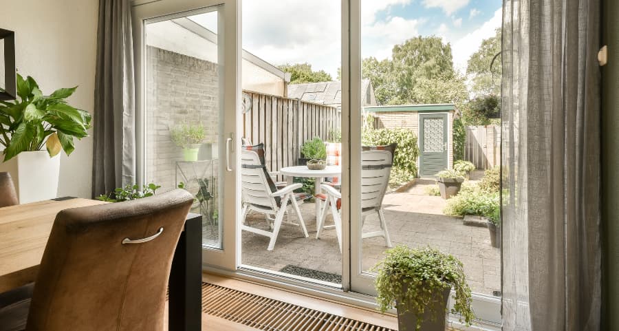 Sliding glass door at home leading to a back patio
